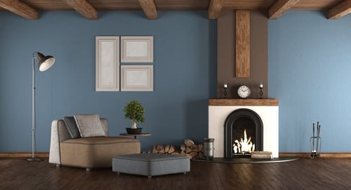 Freshly painted living room with a deep blue accent wall and fireplace